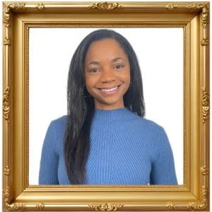 Smiling woman in a gold frame portrait.