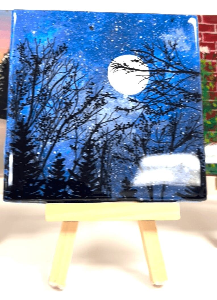 Moonlit forest painting on small easel.